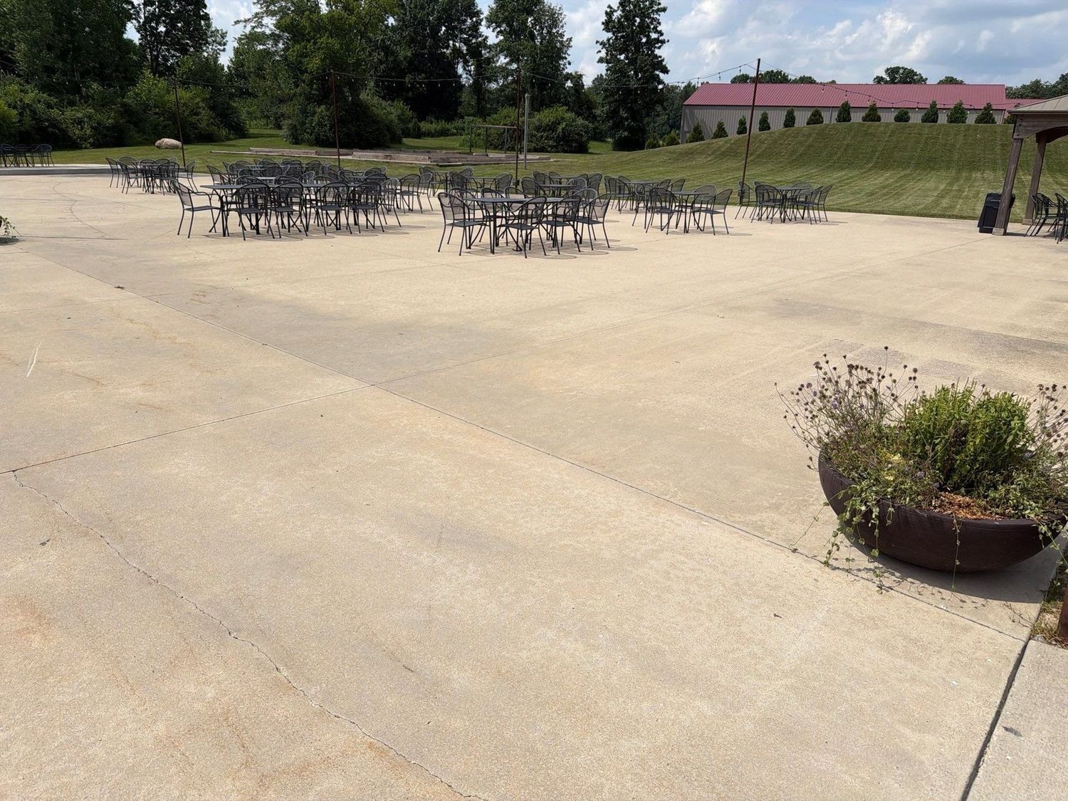 Large cleaned concrete patio set with tables and chairs at a McCordsville venue