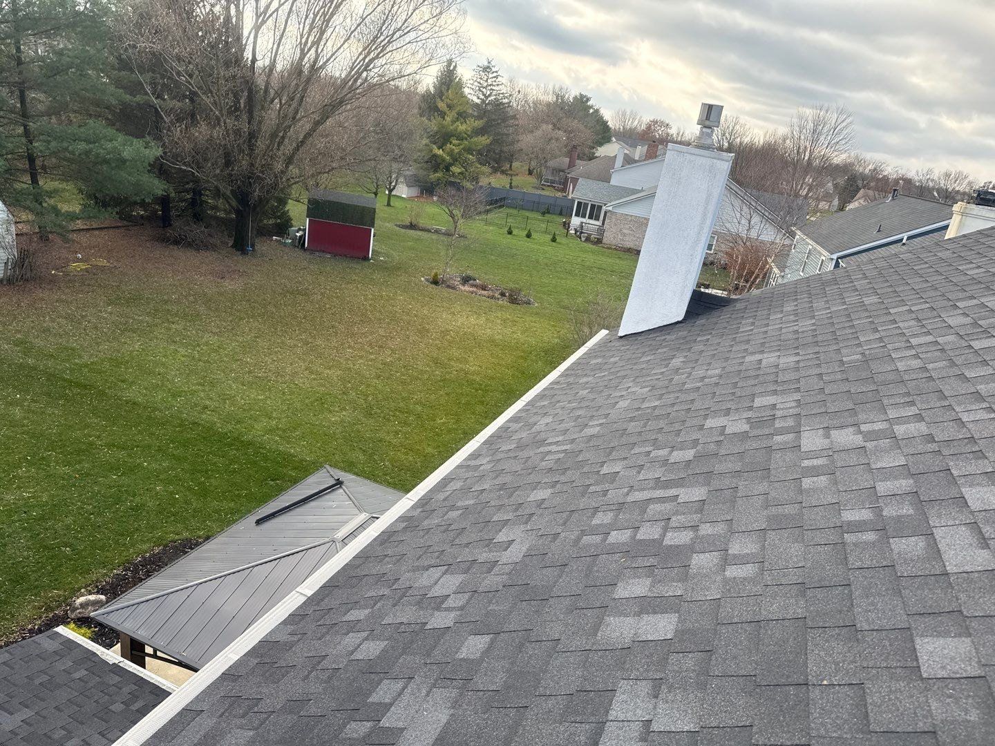 Asphalt shingle roof slope on a Carmel home after a soft wash roof cleaning