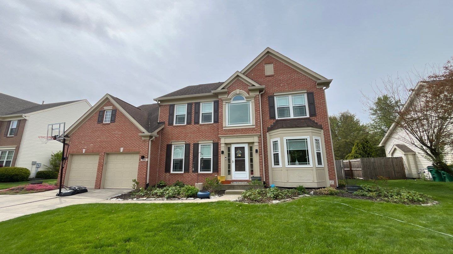 Tan brick and siding Fishers home after a full exterior wash