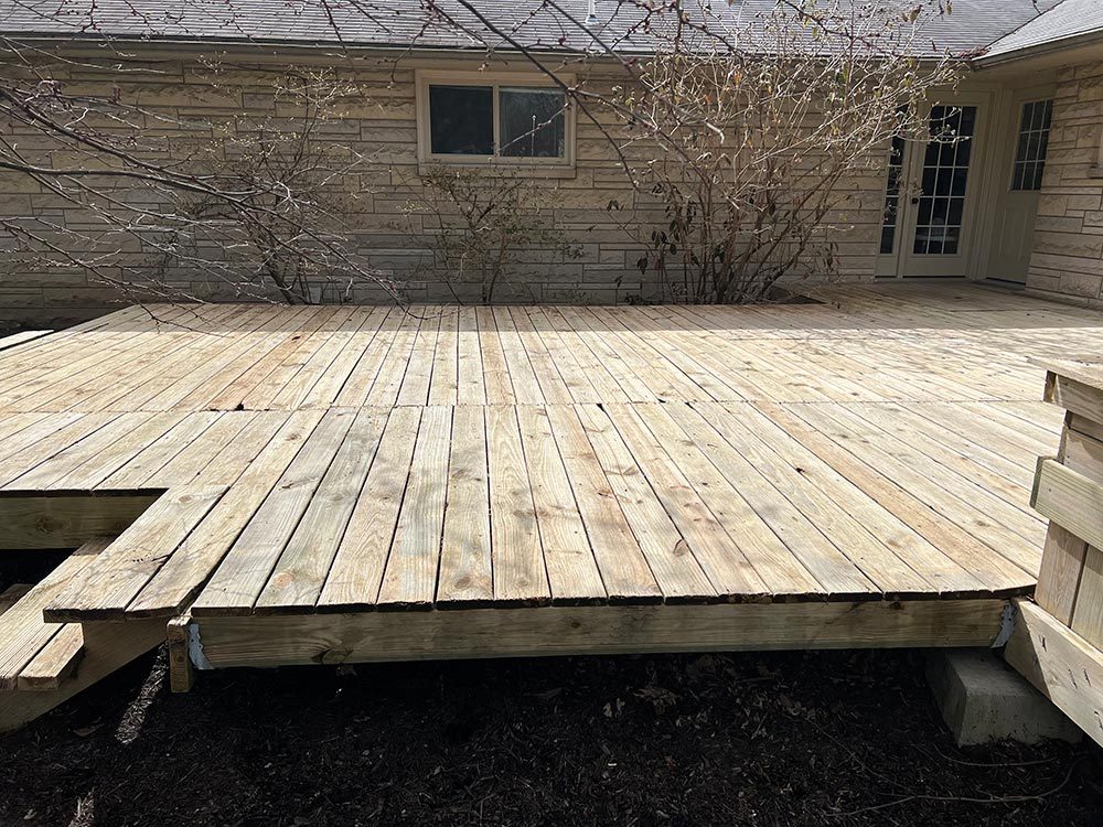 Weathered gray deck boards on an Indiana home before cleaning